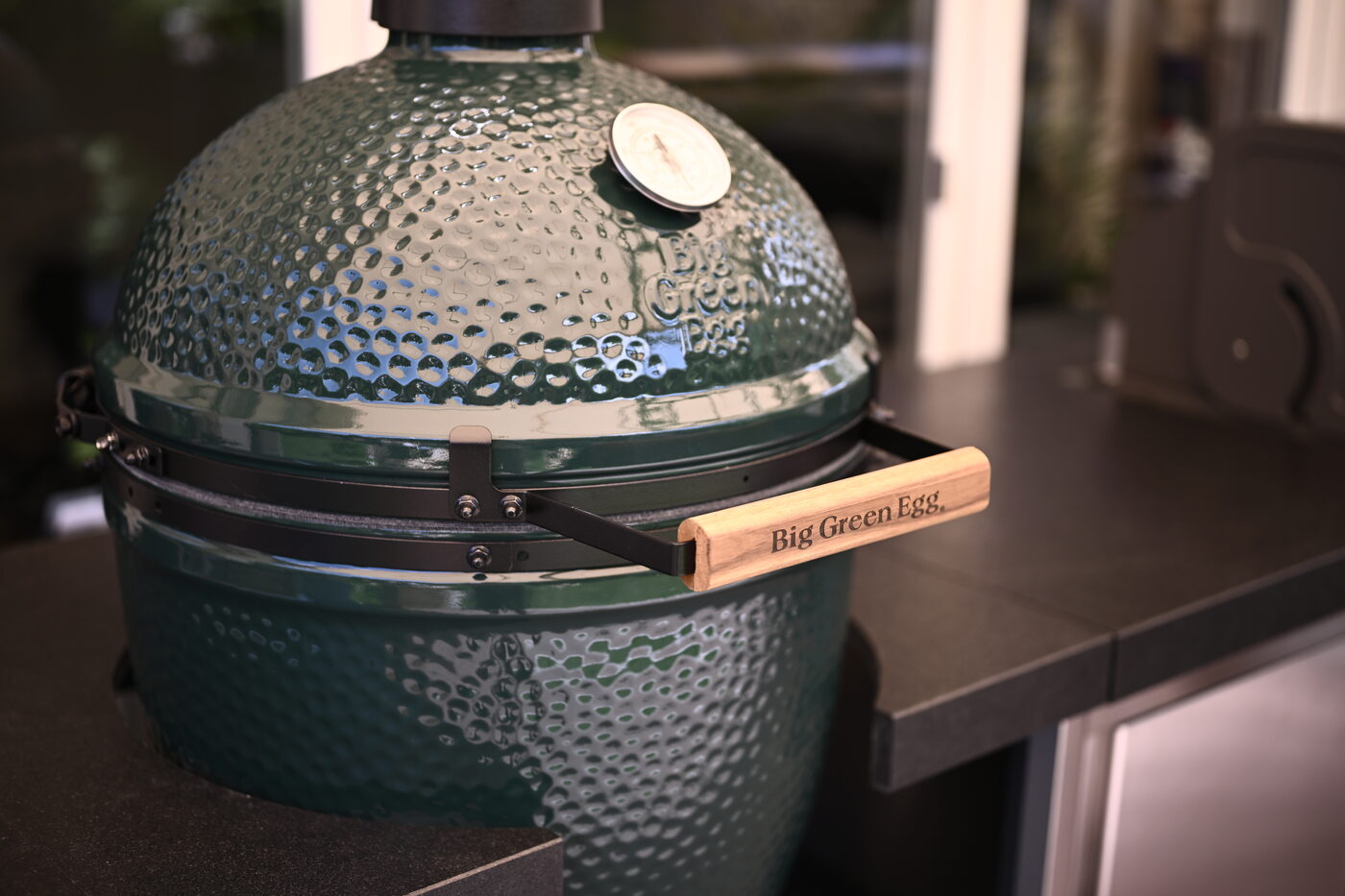 Big Green Egg Keramikgrill mit graviertem Holzgriff in der Outdoor-Küche